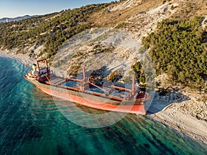 Aerial view of cargo ship run aground on wild coast, shipwreck after storm