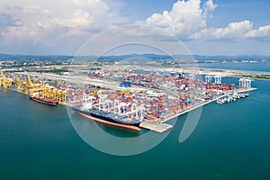 Aerial view of cargo ships loading containers at seaport