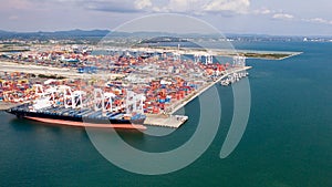 Aerial view of cargo ships loading containers at seaport