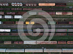 Aerial view of a cargo trains. Colorful freight trains on the railway station. Heavy industry