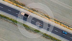 Aerial view of cargo truck driving on highway hauling goods. Delivery transportation and logistics concept