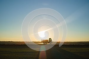 Aerial view of cargo truck driving on highway hauling goods. Delivery transportation and logistics concept