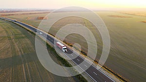 Aerial view of cargo truck driving on highway hauling goods. Delivery transportation and logistics concept