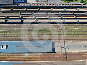 Aerial view on cargo wagons on train station in city