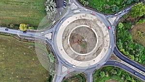 Aerial view of cars driving in a circle in city traffic. High quality 4k footage