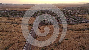 Aerial view of cars driving on a road through the Sonoran Desert
