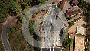 Aerial view of cars entering a tunnel