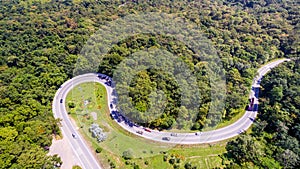 Aerial view of cars are going through a curve road