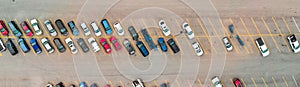 Aerial view of cars at large outdoor parking lots, USA. Outlet mall parking congestion and crowded parking lot, other cars try