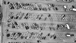 Aerial view of cars at large outdoor parking lots, USA. Outlet mall parking congestion and crowded parking lot, other cars try