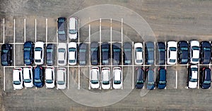 Aerial view cars for sale stock lot row, Car Dealer Inventory, parking lot. black and white new cars are in row