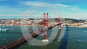 Aerial view of cars traffic on the red 25 De April Bridge. Lisbon, Portugal.