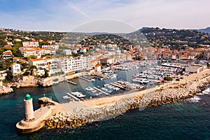 Aerial view of Cassis cityscape on Mediterranean coast with marina and lighthouse