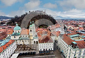 Aerial view of castle in Ljubljana, Slovenia surrouded by buildings photo