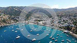 Aerial view of Catalina Casino and Avalon harbor with sailboats.