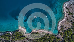 Aerial view of Catamaran and yacht in the sea near Greek island