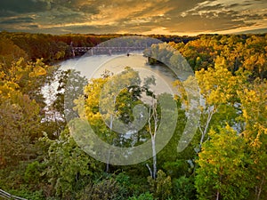 An aerial view of the Catawba river with a train trestle in the background.