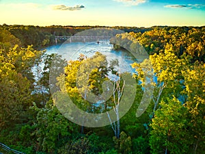 An aerial view of the Catawba river with a train trestle in the background.