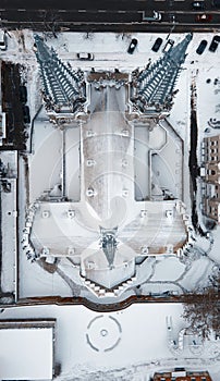 Aerial view of the catholic gothic church with towers under the snow