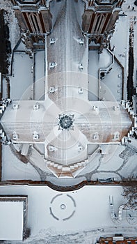 Aerial view of the catholic gothic church with towers under the snow