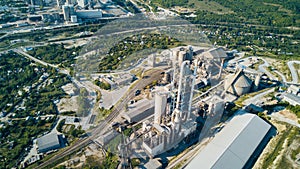 Aerial view of cement manufacturing plant. Concept of buildings at the factory, steel pipes, giants.