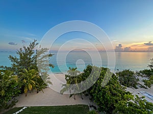 An aerial view of Cemetery Beach on Seven Mile Beach in Grand Cayman Island with a beautiful sunset
