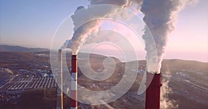 Aerial view of Central Heating and Power Plant chimneys with steam. Sunrise