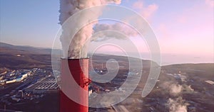 Aerial view of Central Heating and Power Plant chimneys with steam. Sunrise