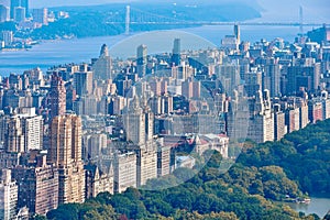 Aerial view of Central Park and row of buildings on the Upper West Side. Hudson River and George Washington Bridge in the
