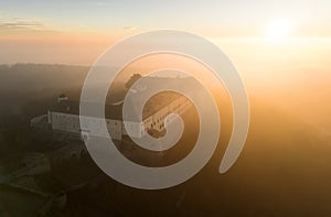 Aerial view of Cerveny Kamen, Red stone castle in the Carpathian mountains in Slovakia dramatic sunrise