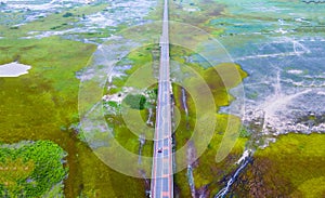 Aerial view of Chalerm Phra Kiat road or Ekachai Bridge cross the lake at Phatthalung, Thailand