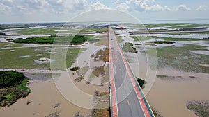 Aerial View of Chaloem Phrakiat - the Longest Bridge in Thailand. Top View of Highway Road at Thale Noi Wetlands in