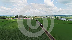 Aerial View Chasing a Steam Passenger Train Traveling Thru Farm Lands