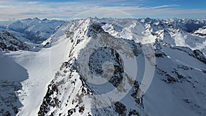 Aerial view of Cheget mountain range in snow in winter in sunny clear weather