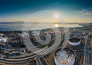 Aerial view of Chemical plant at sunset, oil refining, smoke, pipes, ecology pollution, air infection, coast of sea in