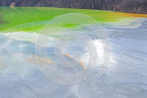 Aerial view of chemical residuals flooding a lake from a copper mine exploitation