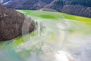 Aerial view of chemical residuals flooding a lake from a copper mine exploitation