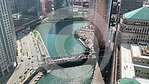 Aerial view of Chicago Loop and Chicago River, as skyscrapers cast shadows onto the river`s surface