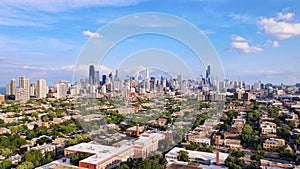 Aerial view of Chicago skyline featuring several tall buildings framed by lush green tree