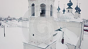 Aerial view Christianity church dome bell cross female nun going to door cathedral winter snowfall