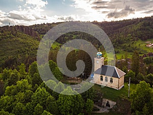 Aerial view of a church in greenery on a cloudy morning