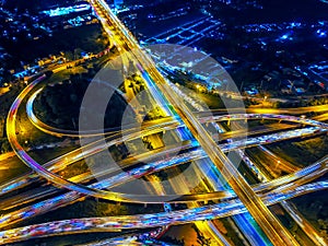 Aerial view of Circle Road traffic in roundabout and highway at night. Expressway, Modern transportation, Multilevel junction