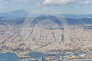 Aerial view of the city of Barcelona, sea and cityscape, mountains and sky.