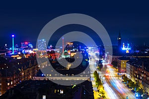 Aerial view of city center at night in Copenhagen, Denmark with car traffic