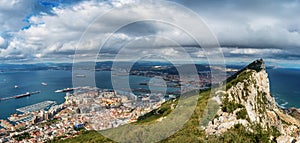 Aerial view on city of Gibraltar from Upper Rock Natural Reserve: on the left Gibraltar town and bay, La Linea town in Spain