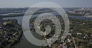 Aerial view of city landscape of Osokorki and Poznyaki district, Kiev Dnipro river and modern skyscrapers 4k 4096 x 2160