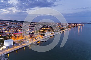 Aerial view of the city of Lisbon and the 25 of April Bridge on the background at dusk;