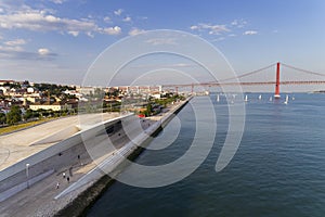 Aerial view of the city of Lisbon with the MAAT museum by the Tagus River and the 25 of April Bridge on the background;