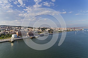 Aerial view of the city of Lisbon with sail boats on the Tagus River and the 25 of April Bridge on the background