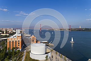 Aerial view of the city of Lisbon with sail boats on the Tagus River and the 25 of April Bridge on the background